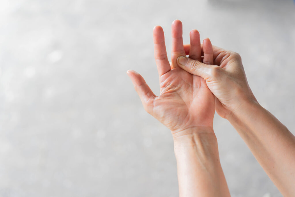 close up senior woman massage on fingers to relieve pain
