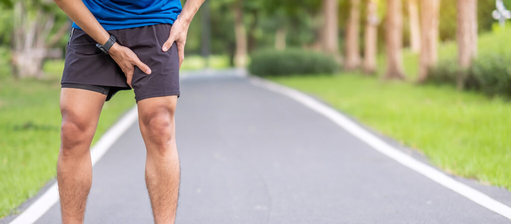 Young adult male with muscle pain during running. runner have leg ache due to Groin Pull. Sports injuries and medical concept.