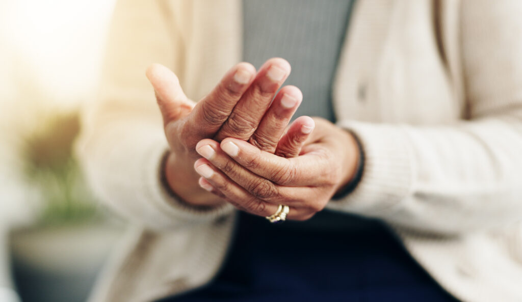 Hand pain, arthritis and gout with closeup of old person for symptoms, accident and injury. Fibromyalgia, tension and circulation with senior woman for osteoporosis, rheumatism and inflammation.
