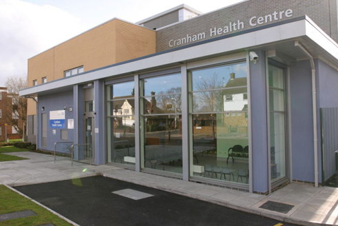Front of Cranham Health centre blue walls with glass sliding doors. 