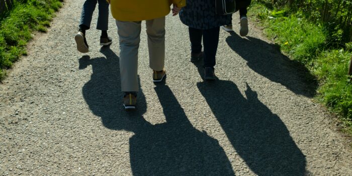 Group of four people walking outdoors