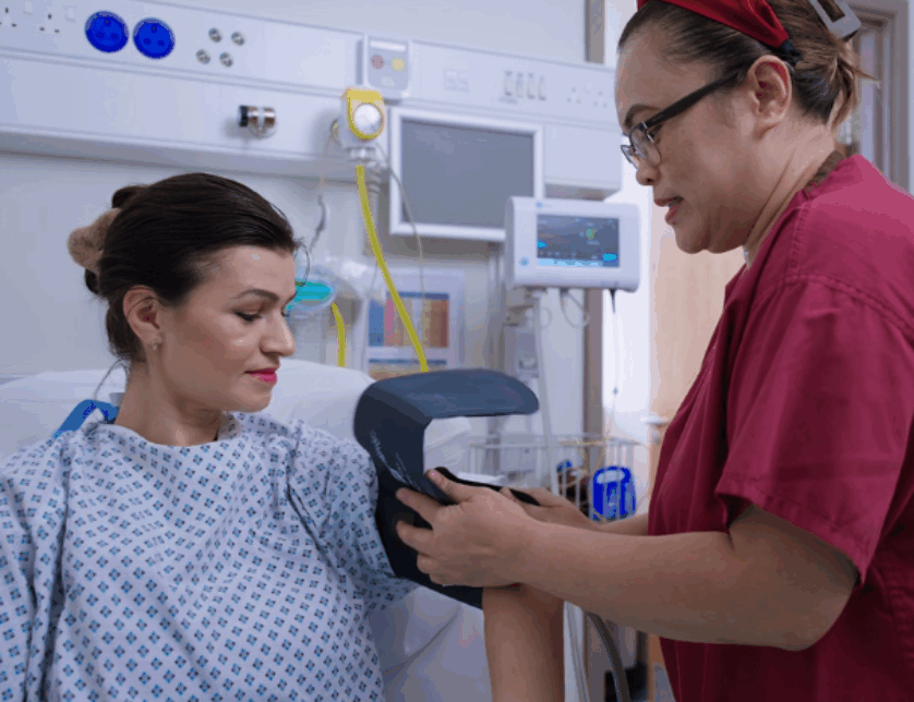 Nurse putting blood pressure band on patient