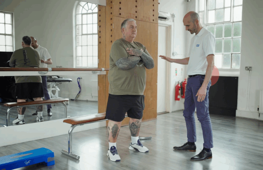 Physio carrying out session with patient in a gym