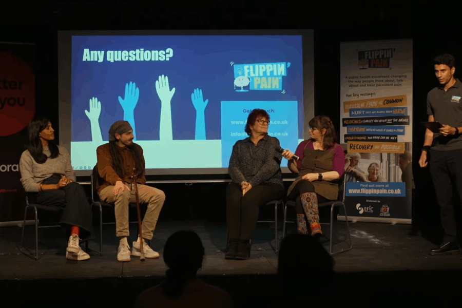 A photo from the discussion panel at our recent Flippin' Pain event. Four people sitting on a stage and one host.